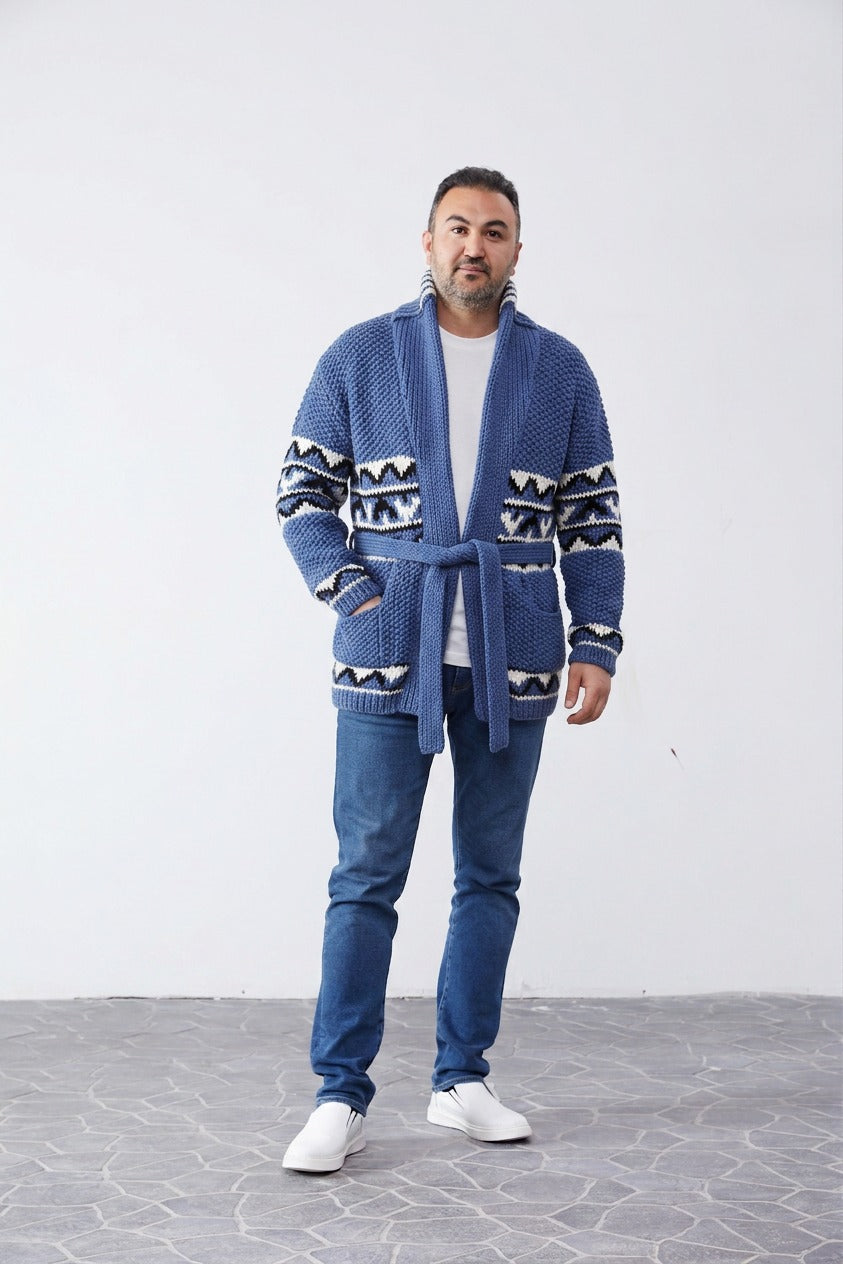 Man wearing the blue Starsky and Hutch hand-knit Cowichan-style cardigan with black and white zigzag pattern bands, shawl collar and tie belt