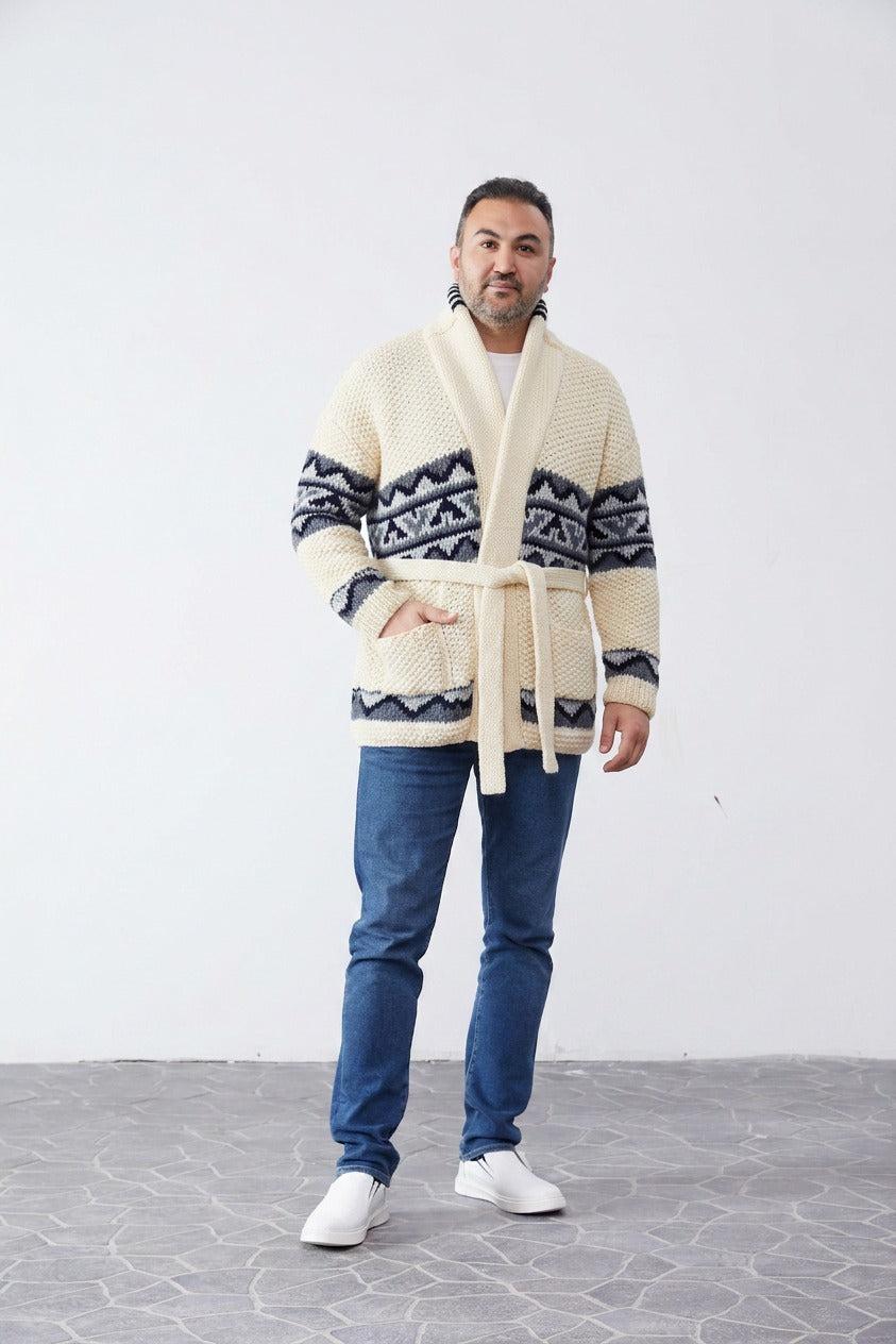 Man wearing the cream Grey Design Starsky hand-knit Cowichan-style cardigan with grey and navy pattern bands