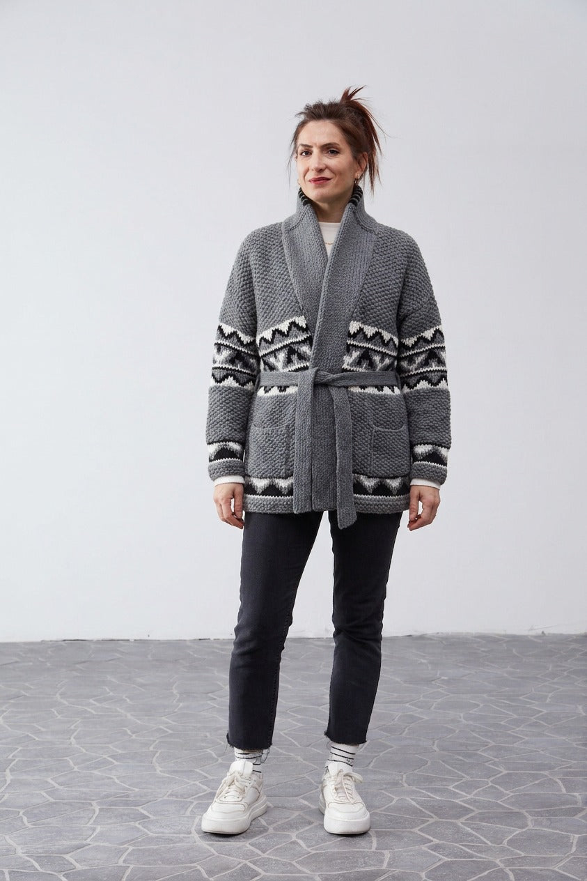 Woman wearing the grey Starsky and Hutch hand-knit Cowichan-style cardigan with shawl collar and tie belt