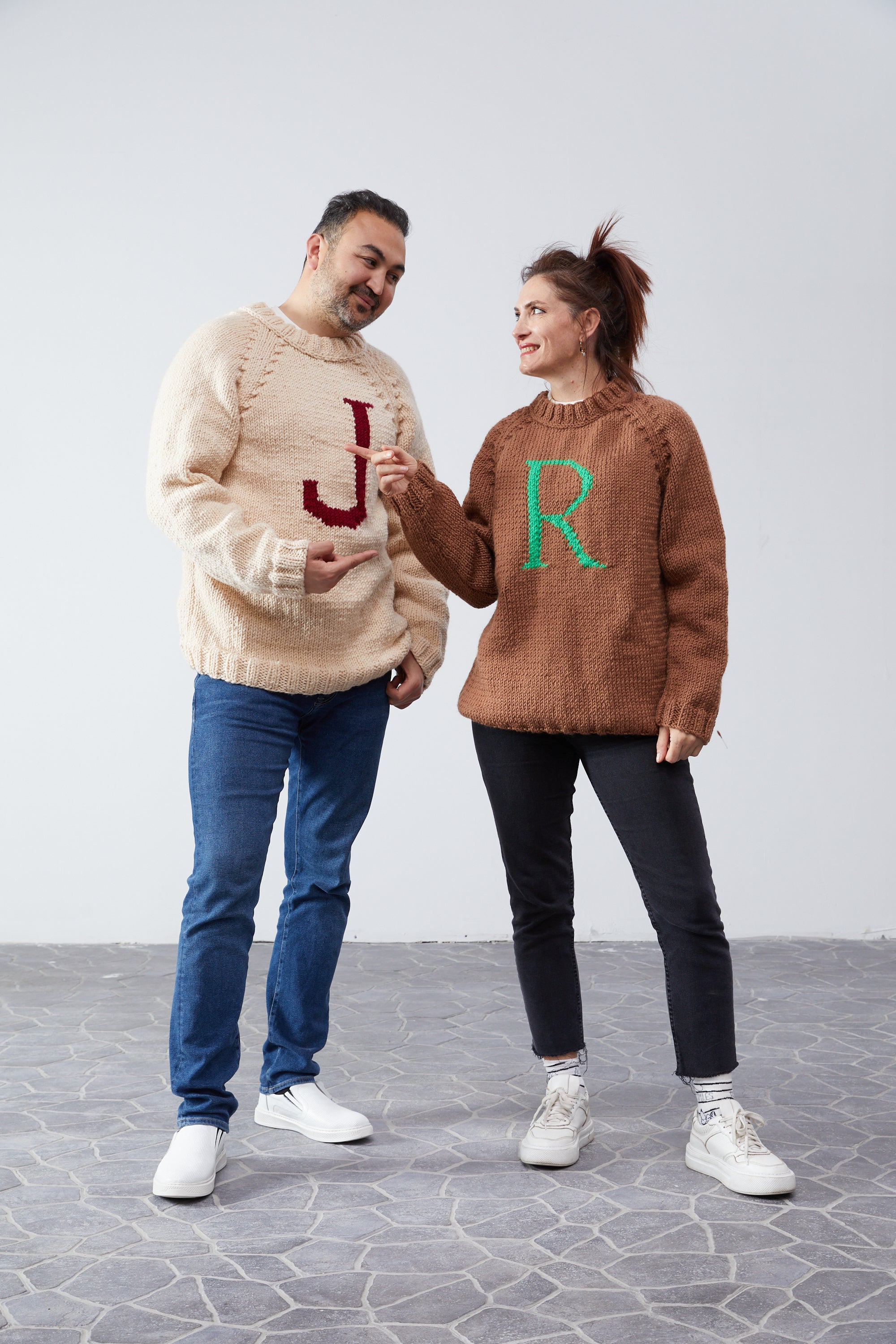 Couple wearing Monogram Weasley jumpers — hand-knit wool sweaters with initial letters