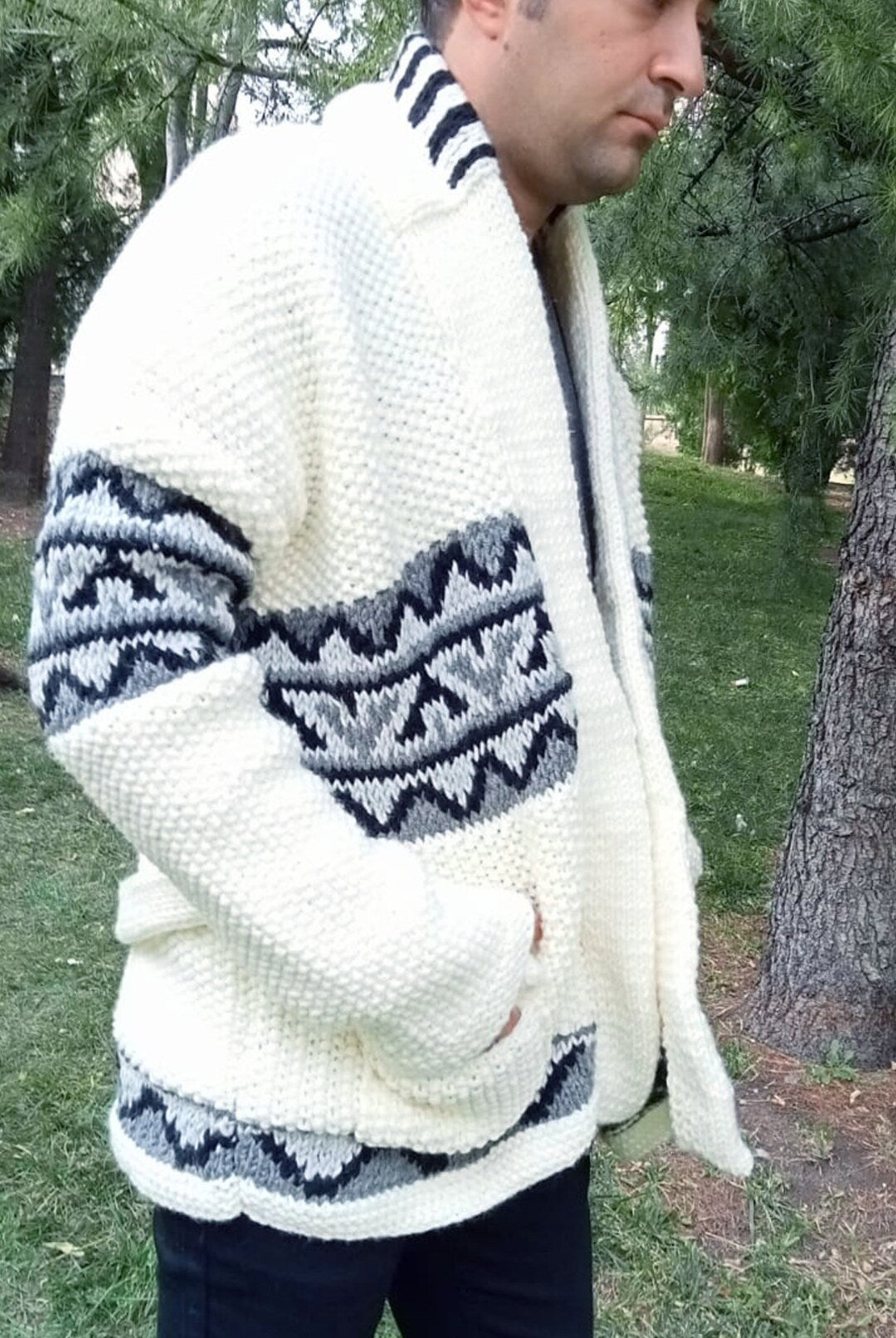 Cream knit cardigan with geometric patterns on sleeves and hem