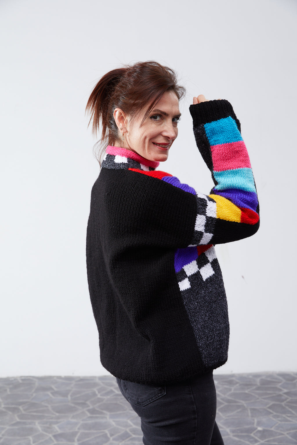 Colorblock sweater three-quarter back view with color-bar sleeves